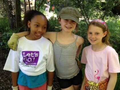 three kids standing next to each other